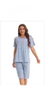 Detail view of light blue cotton pajamas with pink dots and a round neck design