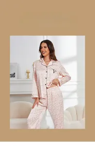Detail view of pink leopard print silk pajama set with black piping and pocket embroidery