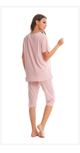 Detail view of pink polka dot cotton pajama set with short sleeve top and cropped pants