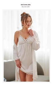 Macro detail of white satin sleepwear set with floral lace trim on robe and nightdress
