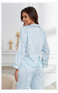 Detail view of light blue leopard print silk pajamas with elegant black piping on back