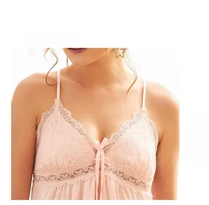 Close-up of light pink lace V-neck nightgown featuring delicate bow detail and straps
