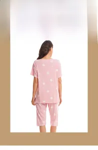 Detail of pink cotton pajamas with white heart prints and short sleeves on model back