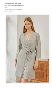 Detail of soft gray modal bathrobe with white lace sleeve trim and waist tie closure