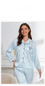 Detail view of light blue leopard print silk pajamas with chest pocket and V embroidery