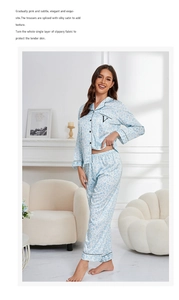 Close-up of light blue leopard print silk pajamas with black piping and pocket detail
