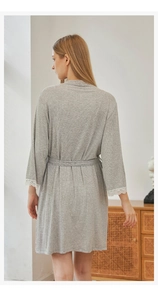 Detail of grey modal cotton robe with delicate white lace trim on sleeves and belted waist