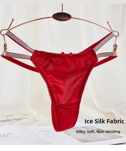 Detail of red ice silk thong featuring a silky texture and decorative front bow detail
