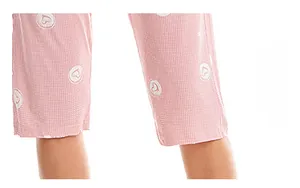 Detailed view of pink heart print cotton pajamas pants featuring white micro-check patterns