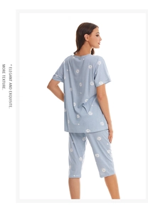Light blue pajama set with white heart patterns featuring short sleeves and cropped pants