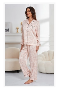 Pink leopard print silk pajama set with long sleeves and black piping detail