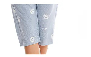 Detailed view of light blue shorts with heart patterns and grape lettering