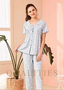 Detail of blue striped cotton pajama set with lace collar and heart prints