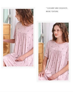 Detail of light pink floral nightgown with elegant pleats and soft cotton texture