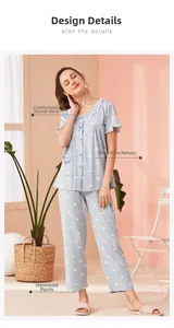 Detail of short-sleeved cotton pajama top with lace round neck and blue heart patterns