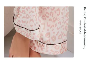 Close-up of pink leopard print pajama pants showing comfortable black hemming detail