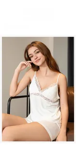 Detail view of white modal sleepwear set with delicate lace trim on camisole and shorts
