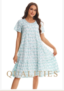 Detail of light blue tiered summer nightdress with short sleeves and floral print