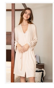 Detailed view of light pink modal robe with white lace cuffs and V-neckline lace trim