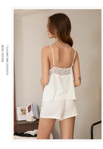 Detail of white modal pajama set showing exquisite lace patchwork on the back of camisole