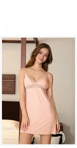 Detail of light pink modal nightgown with deep V-neck and delicate lace embroidery trim