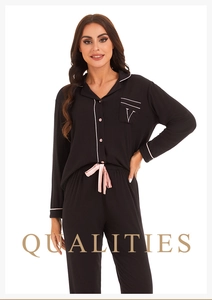 Detail of black modal pajamas with pink trim, chest pocket embroidery, and silk drawstring