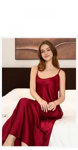 Detail view of burgundy satin slip nightdress with high side slit and smooth texture