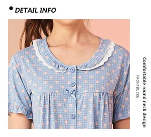 Detail of round neckline with white lace trim and blue bow on cotton pajamas