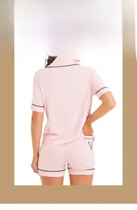 Back view of pink modal pajama set with black trim and V logo on the back pocket