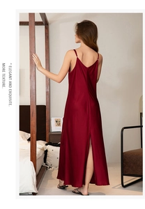 Macro detail of dark red satin sleepwear showing side slit and silk texture