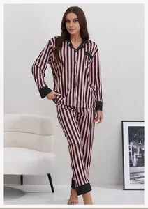 Detail of pink and black striped women's pajama set with notch collar and chest pocket