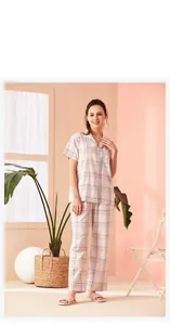 Detailed view of women's pink plaid pajamas set with button-down shirt and long pants