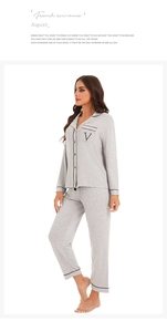 Detail of grey modal cotton pajama set with black piping and letter V embroidery
