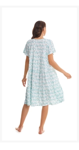 Rear view of a tiered summer nightdress with light blue floral patterns on white cotton