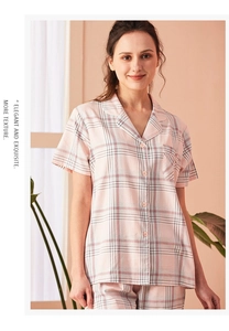 Detail of pink plaid pajama set featuring lapel collar, buttons, and breast pocket