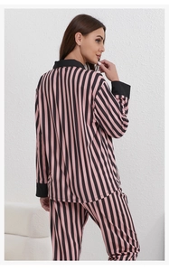 Detailed back view of pink and black striped women pajamas with contrast cuffs and collar