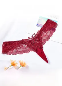 Close-up of deep red lace thong featuring an intricate butterfly applique and mesh texture