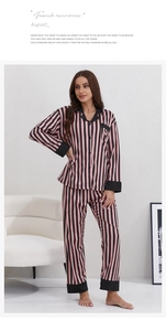 Detail of pink and black striped long-sleeve pajama set with contrast cuffs and collar
