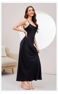Elegant black silk-like long slip dress with spaghetti straps and a smooth drape finish