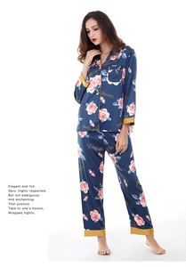 Detail of navy silk pajama set with pink floral prints and gold piped collar