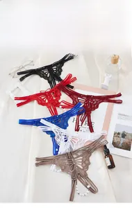Vue détaillée de strings en dentelle avec motif papillon et ornements de perles