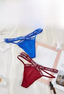 Lace thong set with Sexy Goddess waistband lying on white silk with accessories
