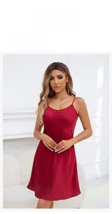 Detail view of a luxury red satin nightgown with slim straps and glossy finish