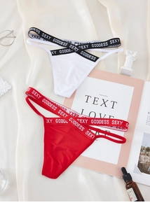 Detailed view of red and white lace thongs with SEXY GODDESS lettered waistbands
