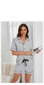 Close-up of gray modal cotton pajama set featuring black contrast piping and drawstring bow