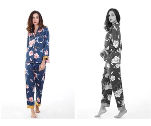 Detail of silk-like navy pajama set with pink rose patterns and elegant gold piping