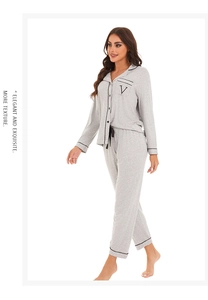 Detail of grey modal pajama set showing black contrast stitching and V-letter pocket