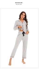 Detail showing grey ribbed cotton pajamas with contrast black piping and V-letter embroidery