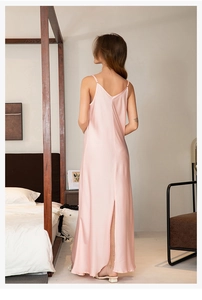 Detail of elegant satin slip nightgown featuring a high back slit and glossy pink fabric