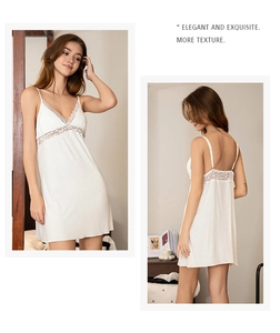 Close-up of white modal nightgown featuring delicate lace trim and v-neck detail